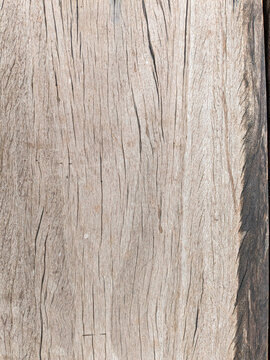 The texture of the wooden planks on the old bridge connecting the villages used by local residents to move from one location to another. This bridge can only be crossed by motorbikes and pedestrians.