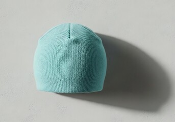Knitted headgear in a vibrant turquoise hue isolated against a subtle surface