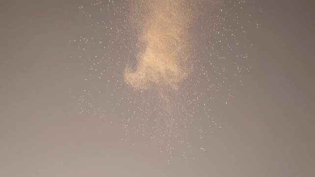 Abstract smoke pattern ascending in soft brown tones on gray background  