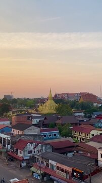 Aerial and panorama view of the capital city of Vientiane, Laos or Lao PDR with the view of Thatluang golden stupa over the sunset sky on a beautiful summer sunshine blue sky day 