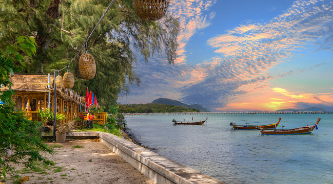 Colourful Skies Sunset over Rawai Beach in Phuket island Thailand. Lovely turquoise blue waters, lush green mountains colourful skies and beautiful views of Pa Tong Patong