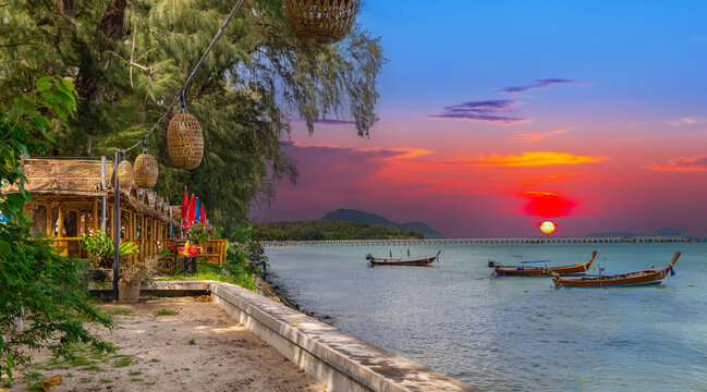 Colourful Skies Sunset over Rawai Beach in Phuket island Thailand. Lovely turquoise blue waters, lush green mountains colourful skies and beautiful views of Pa Tong Patong