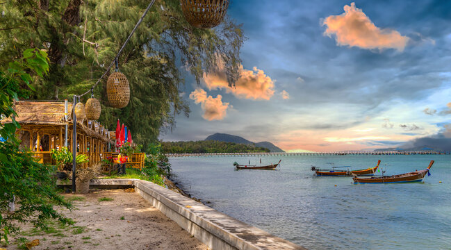 Colourful Skies Sunset over Rawai Beach in Phuket island Thailand. Lovely turquoise blue waters, lush green mountains colourful skies and beautiful views of Pa Tong Patong