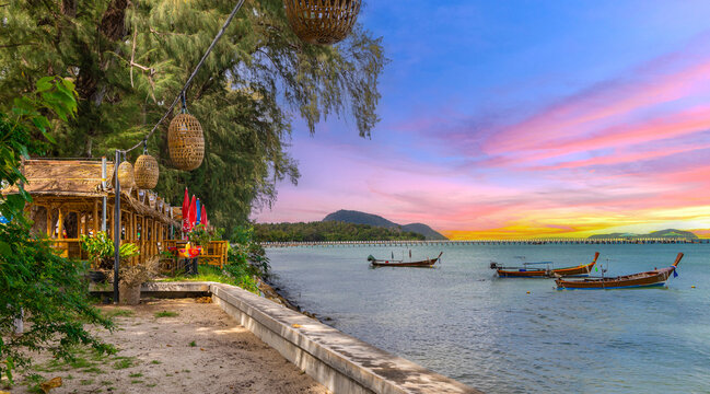 Colourful Skies Sunset over Rawai Beach in Phuket island Thailand. Lovely turquoise blue waters, lush green mountains colourful skies and beautiful views of Pa Tong Patong