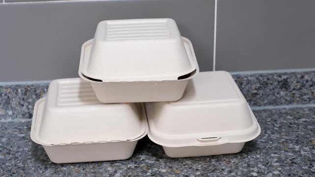 Three cardboard boxes of food in kitchen, food delivery concept.