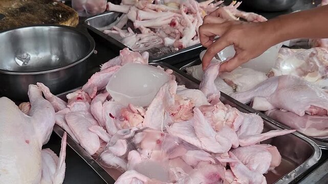 Fresh Poultry Selection Traditional Market Display. Raw Chicken Cuts Vendor Counter With Ice. Butcher Stall Offering Organic Protein Portions. Wet Market Meat Assortment Retail Scene