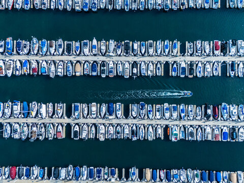 Aerial view of Long Beach marina with luxury yachts and speedboat wake, coastal waterfront real estate and investment concept in Southern California
