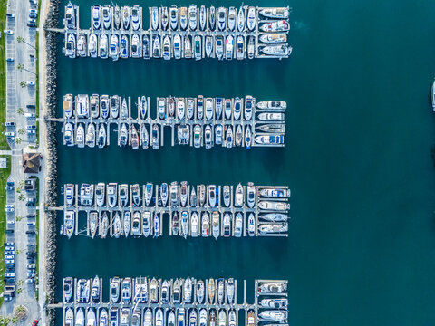 Top down aerial view of Long Beach marina with aligned yacht docks and luxury boats, coastal real estate and investment concept in Southern California