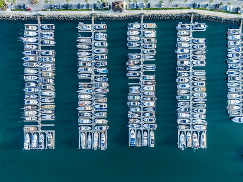 Top down aerial view of Long Beach marina with aligned yacht docks and luxury boats, coastal real estate and investment concept in Southern California