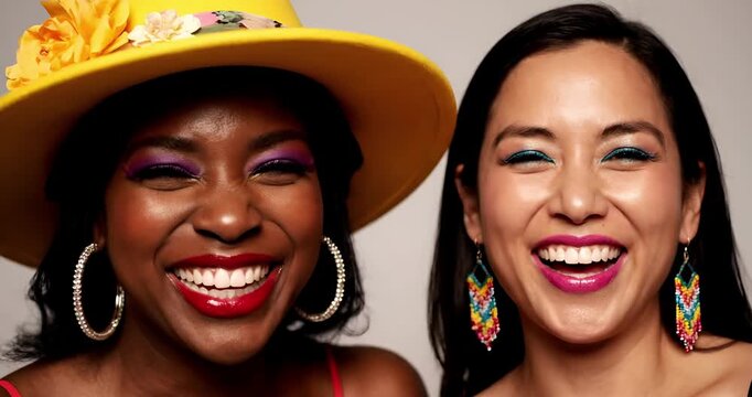 Close up portrait of two multiethnic female friends laughing with real joy
