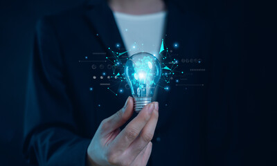 Hand of  holding illuminated light bulb, Idea innovation and inspiration concept.  creativity with bulbs that shine glitter, Concept for success. © tinh