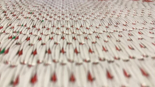close up view of Traditional mat or tikar texture. pattern. detail, detailed. white, red. indonesia. copy space, empty, free, negative, text, design. front, side. background, backgrounds.