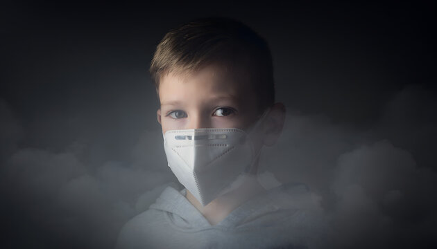 A young boy with blue eyes wearing a white protective face mask in a smoky or foggy environment, looking directly at the viewer  symbolizing air pollution and environmental health concerns