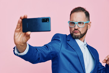 Professional businessman with a confident expression takes a self portrait against an isolated...