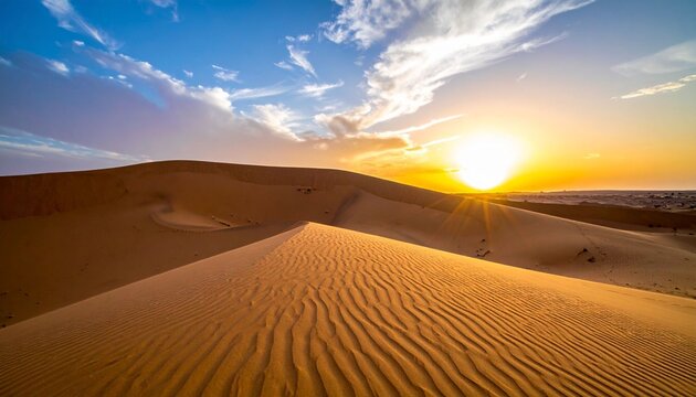 Golden sunset and sunrise glow over the Sahara desert sand dunes in a hot summer landscape under an orange horizon sky for a dry wilderness travel adventure in Morocco
