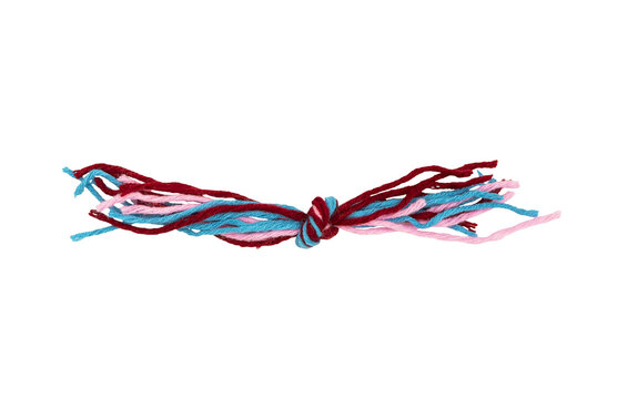Twisted yarn bracelet or friendship string tied in a knot, red blue and pink strands isolated on Transparent background, handmade textile craft with copy space.