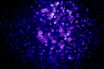 Blurred photo with purple violet and blue dots visible glittering, shining brightly look and feel luxurious