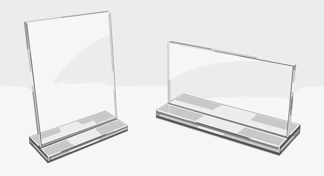 Pair of transparent acrylic sign holders in vertical and horizontal orientations sitting on a plain gray surface for display.