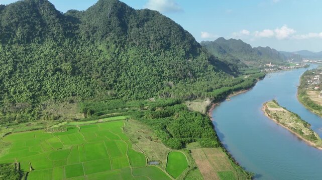 Phong Nha &ndash; Ke Bang National Park, Bo Trach, Quang Binh, Central Vietnam &ndash; 4K aerial footage of UNESCO Heritage site with Son River, limestone karst mountains, rice fields, tropical forest & cave
