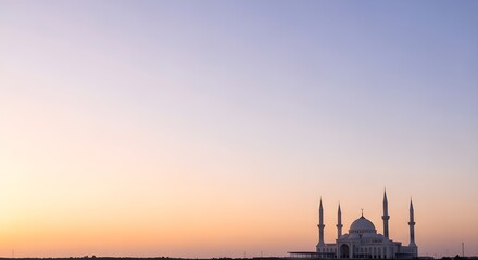 Fototapeta premium Serene evening view of a majestic mosque silhouette with a vibrant orange and purple gradient sky.