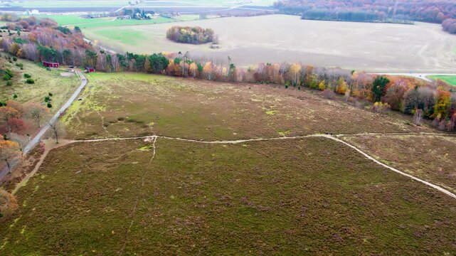 Aerial drone view of hiking trails crossing wetland landscape in Fjaras Bracka nature reserve in Sweden showing open terrain and autumn colors capturing scenic outdoor nature