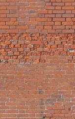 Obraz premium Brick wall with varied textures and patterns in outdoor daylight