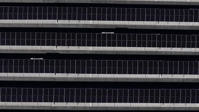 Top down view of rooftop solar panel array with horizontal photovoltaic grid pattern