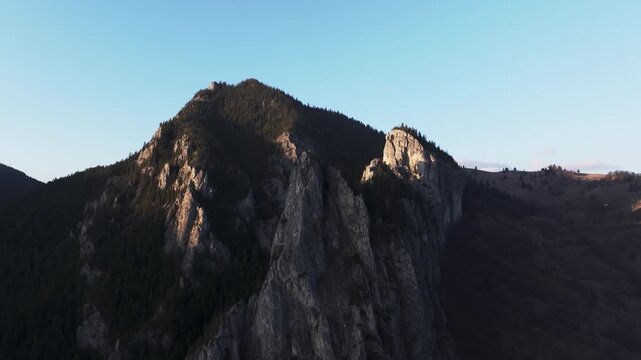 Drone Shot footage capturing the sharp ridges of Cheile Bicazului under the warm glow of a setting sun.