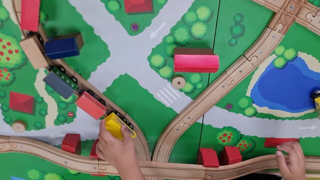 Toy Train Moving on Wooden Railway Track Top View