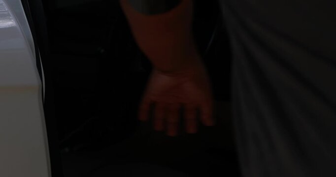 Close up male hand grabbing and pulling chrome car door handle to open a white vehicle, man entering the driver seat to start a road trip journey or daily commute. High quality 4k video footage.