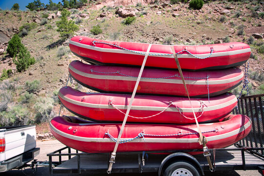 A large trailer full of river rafts ready for adventure on the river. White water expedition concept photo. Outdoor adventure 