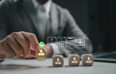 Businessman hand choosing wooden cube block with human resource icon for recruitment process,...