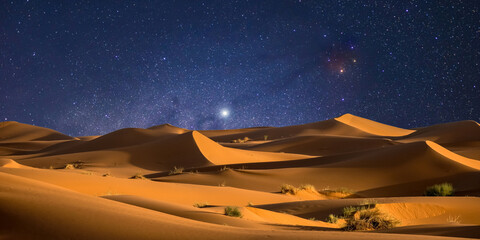 night landscape with desert dunes, starry sky and milky way in desert, abstract background.