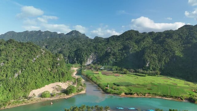 Phong Nha &ndash; Ke Bang National Park, Bo Trach, Quang Binh, Central Vietnam &ndash; 4K aerial footage of UNESCO site with Son River, limestone karst mountains, rice fields, tropical forest & cave entrance