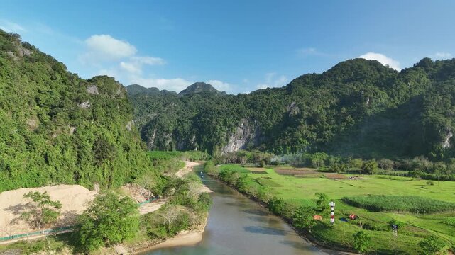 Phong Nha &ndash; Ke Bang National Park, Bo Trach, Quang Binh, Central Vietnam &ndash; 4K aerial footage of UNESCO site with Son River, limestone karst mountains, rice fields, tropical forest & cave entrance
