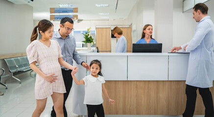 woman is holding a baby in a hospital waiting room