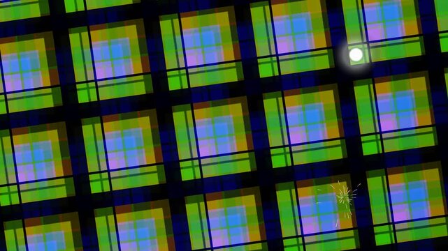 Close-up view of a grid of colorful image sensors with a glowing light in a technological environment