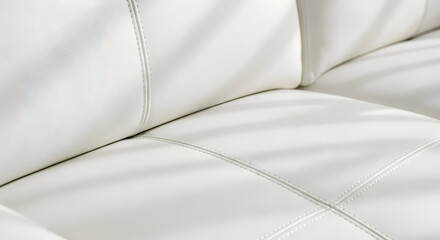 Fototapeta premium Close up of a luxurious white leather sofa with elegant stitching and soft shadows creating a sophisticated and comfortable interior design aesthetic