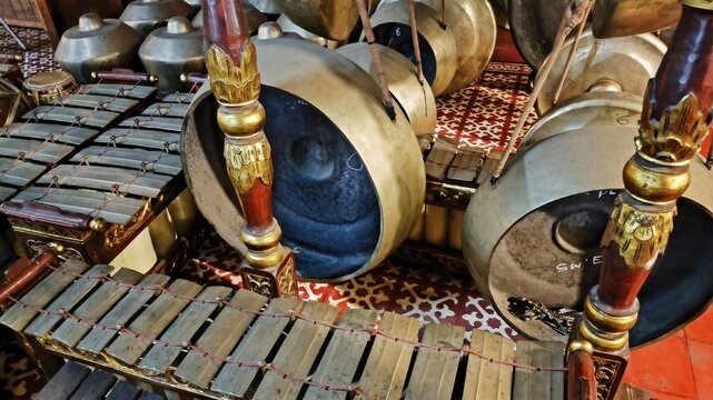 Close up footage of authentic Javanese gamelan percussion instruments with ornate wooden carvings, symbolizing Indonesian rich cultural music heritage and traditional classical performance heritage.