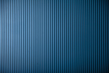 Deep blue corrugated metal background with strong vertical lines creates an interesting modern texture. Provides a clean concept for various design uses and copy-space.
