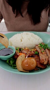 Eating a piece of cha lua or ham in a plate of assorted authentic local vietnamese food showing a candid foodie experience. Central, Hong Kong.