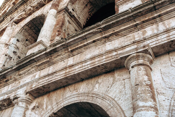 Naklejka premium View of ancient structure from low angle with focus on stone details in daylight