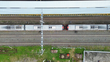Aerial photo train in station is on the tracks next to a building