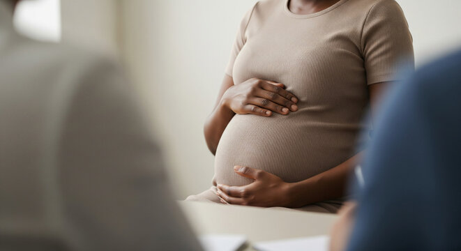 Black pregnant woman during medical consultation for maternity leave benefits