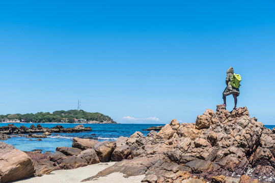Traveler Standing on the Rocky Beach in Trincomalee, Sri Lanka