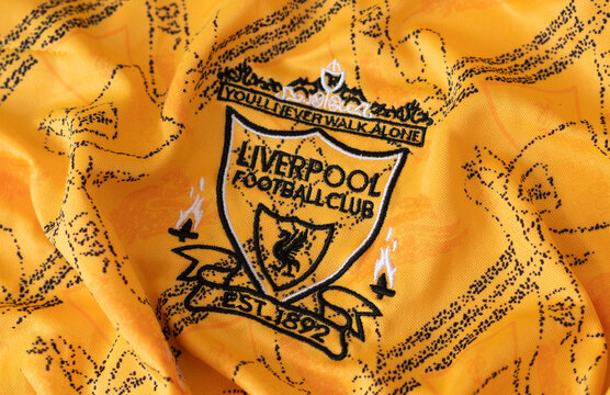 Kyiv, Ukraine. February, 2026. Close-up of the Liverpool Football vintage club crest embroidered on a yellow textured sports jersey fabric. retro logo