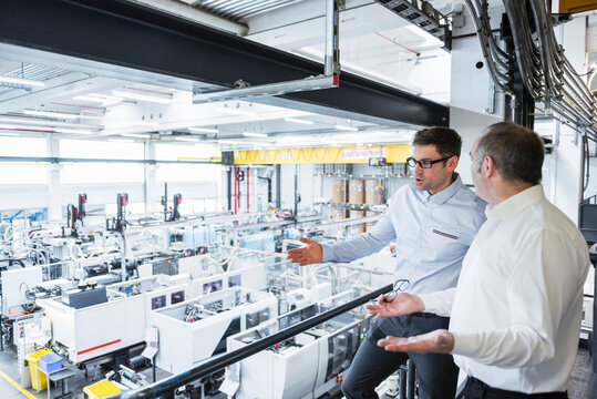 Two men talking in factory shop floor