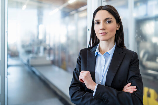 Portrait of confident businesswoman in a modern factory