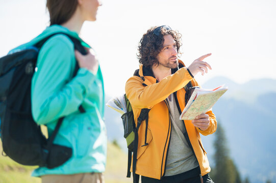 Hiking couple with map, Wallberg, Bavaria, Germany