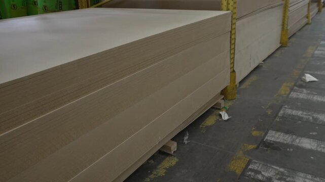 Large storage of various wood panels and timber sheets in a warehouse